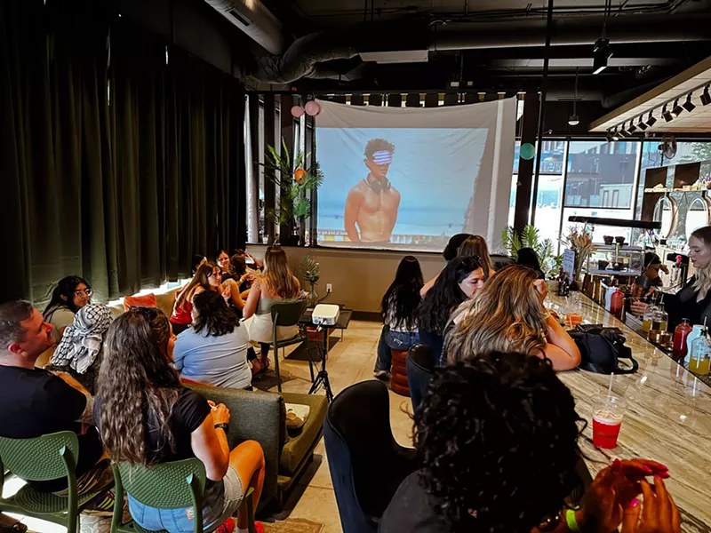 Image: People watch Love Island on a big screen