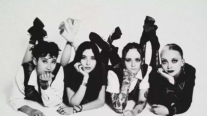 four women posing on the ground