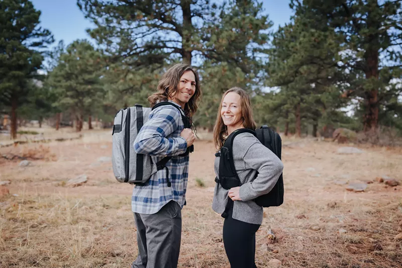 Image: A man and woman show off their backpacks