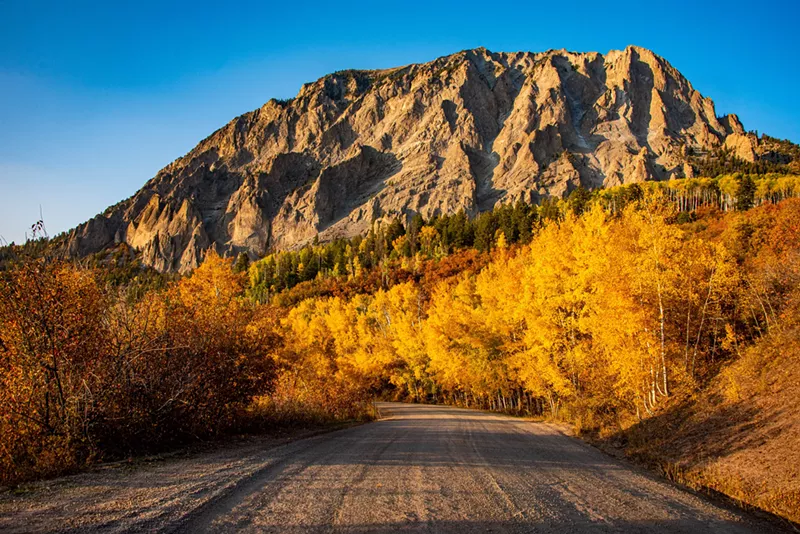 Image: Yellow aspens and a large rocky peak seen from Kebler Pass