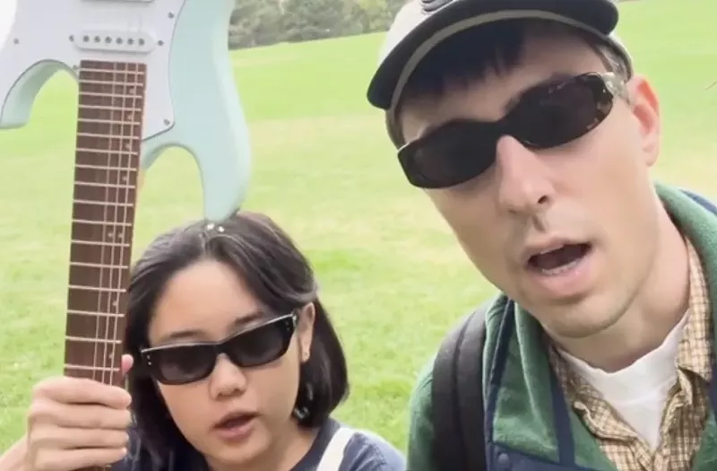 Image: two people with sunglasses in a park