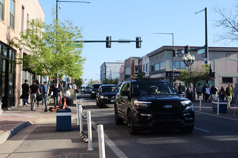 Image: Cars drive down a busy street