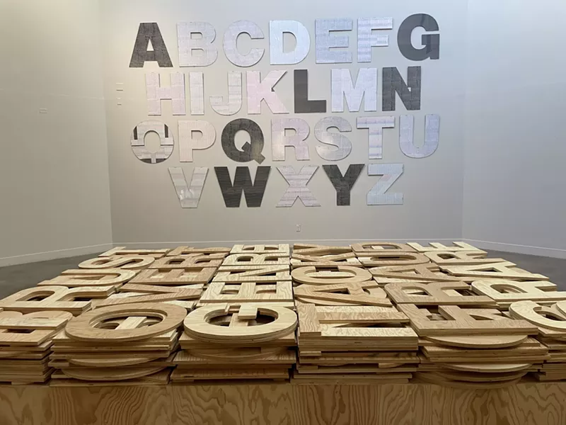 Image: Roland Bernier’s acrylic alphabet (on the wall); “Word Works” (on the floor) at the Arvada Center.
