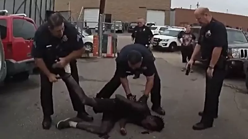 Image: A screen capture from body-worn camera footage of Denver Police officers surrounding Malow Mayek, seventeen, on August 22, 2018.