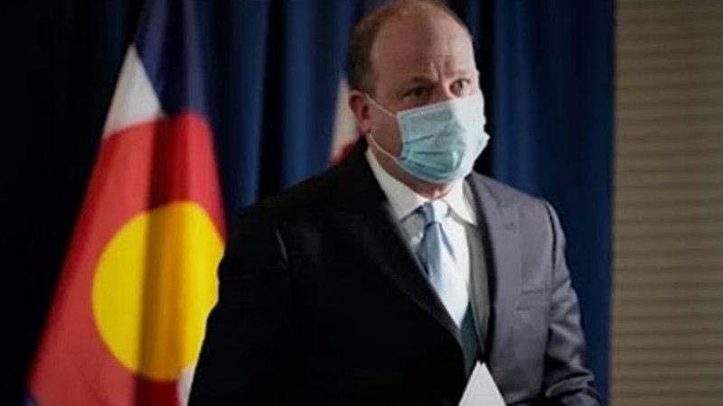 A masked Colorado Governor Jared Polis.