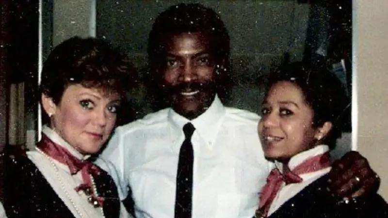 Image: Ruben Lee, center, with fellow flight attendants during an earlier part of his United Airlines career.