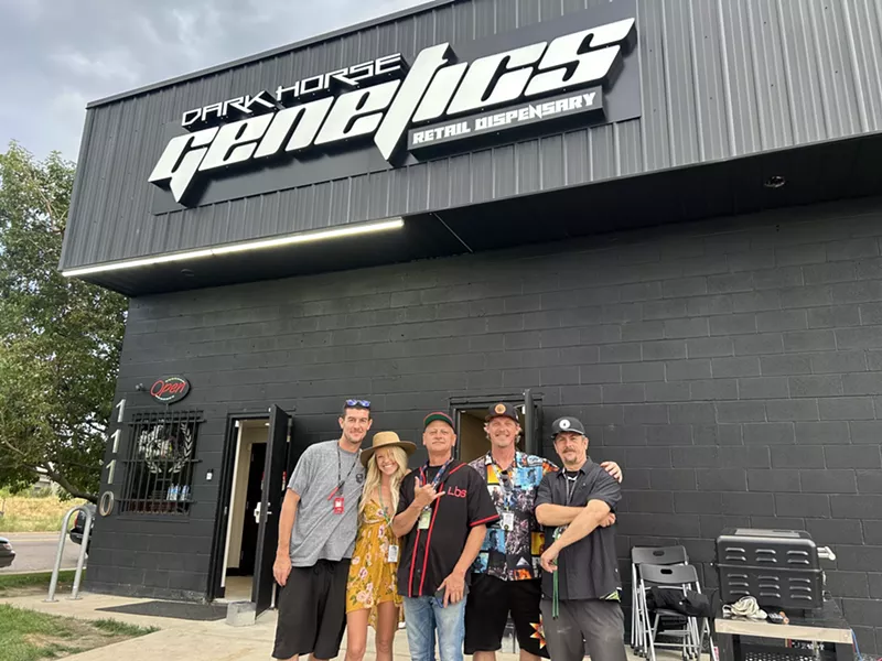 Image: Dark Horse Genetics staff members backdropped by the dispensary's black-painted exterior