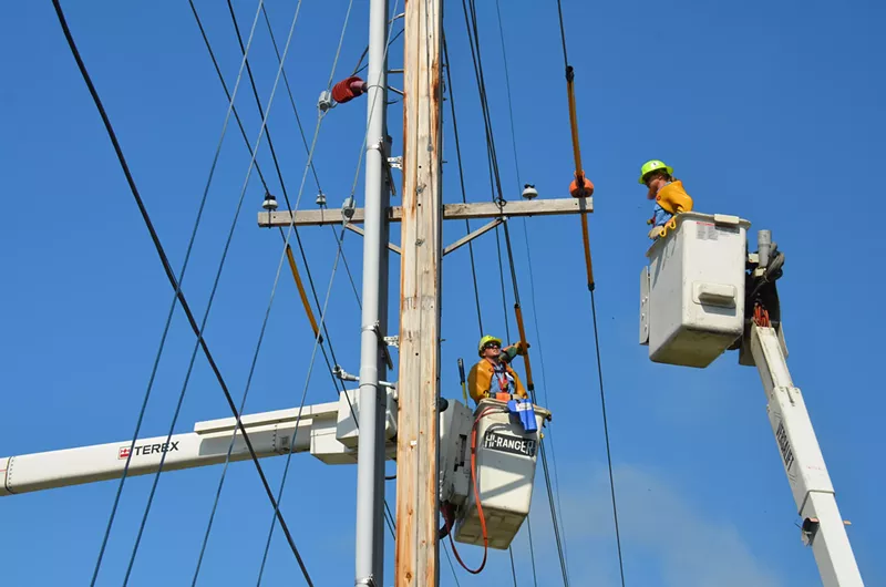 Image: Workers up on an electric pole.