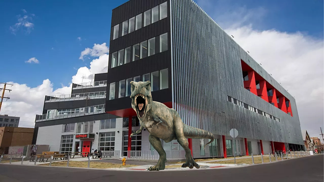 dinosaur in front of a building